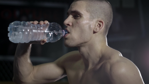 Tired Athlete Drinks Water