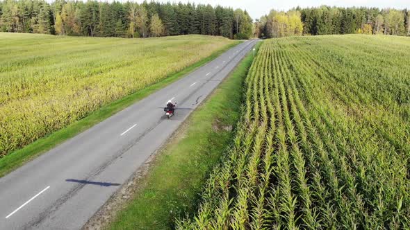 Motorcycle Riding By Country Road on Sunset, Beautiful Adventure Travel Footage Shot From Drone, Top