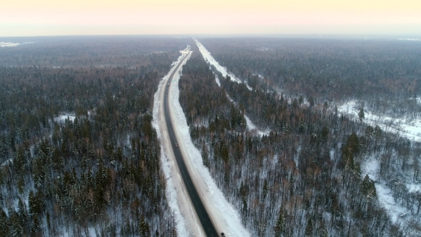 Intercity Highway Among Woodland at Sunset in Winter