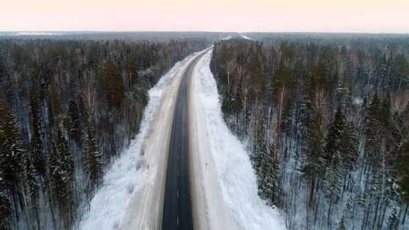 Intercity Highway Among Woodland at Sunset in Winter