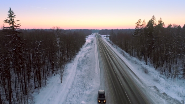 Intercity Highway Among Woodland at Sunset in Winter