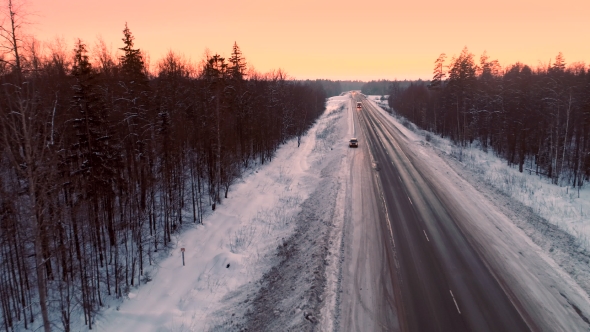 Intercity Highway Among Woodland at Sunset in Winter