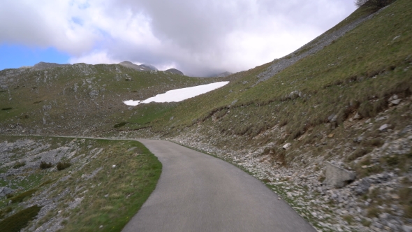 Driving a Car on a Highland Road alt