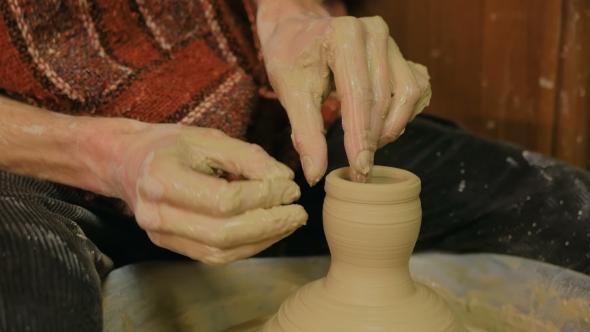 Professional Male Potter Working in Workshop
