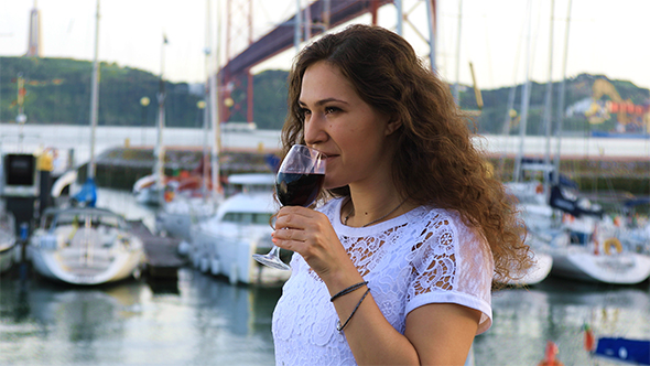 Charming Brunette Girl With a Glass of Red Wine