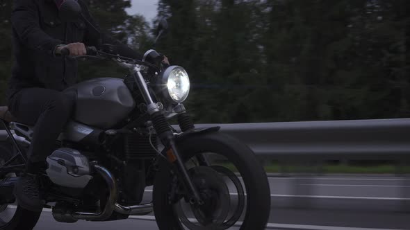 Closeup Shot of Man Riding Scrambler Motorbike on the Highway alt