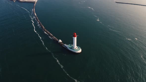 Aerial Shot of White Lighthouse Near Sea Port 360 View alt