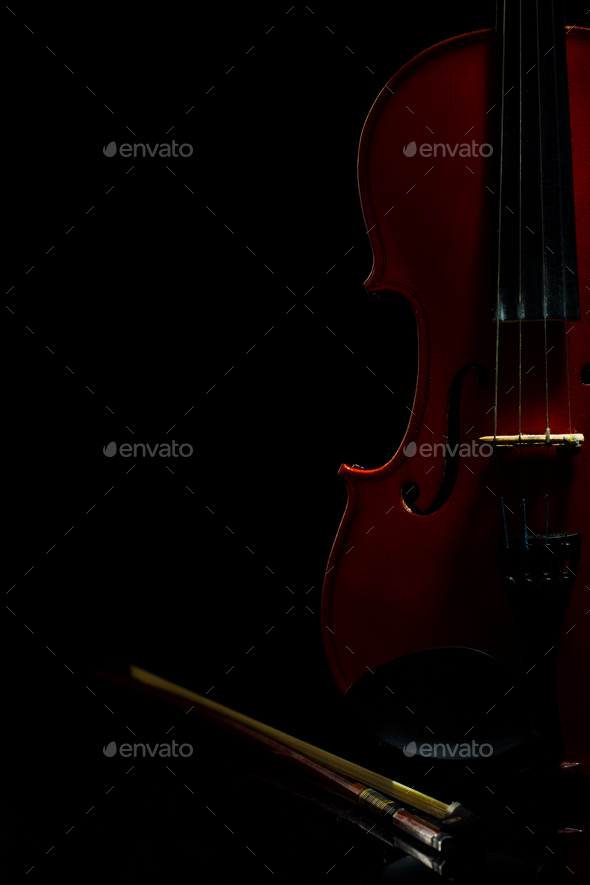 Violin with notes and bow on a black background