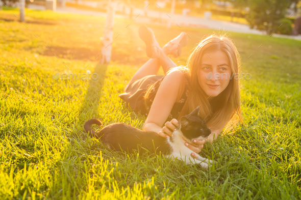 Cute Cat and Woman playing with him Outdoor Lifestyle, Friendship and Pet Owner concept