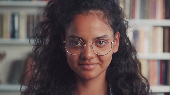 Happy Indian Teenage Girl Laughing at Funny Joke Looking at Camera in Library alt