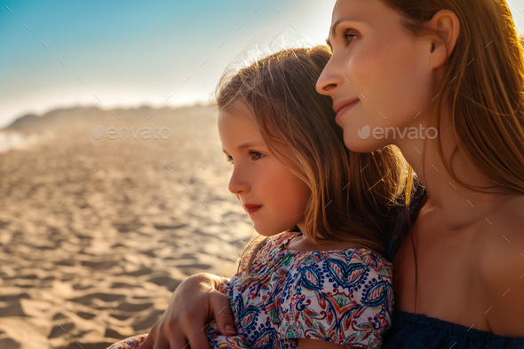 mother with girl watch sunset - Stock Photo - Images