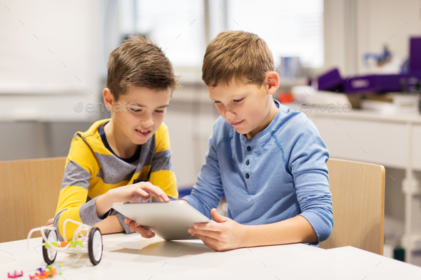 kids with tablet pc programming at robotics school - Stock Photo - Images
