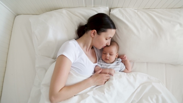Mother Kissing Newborn Baby