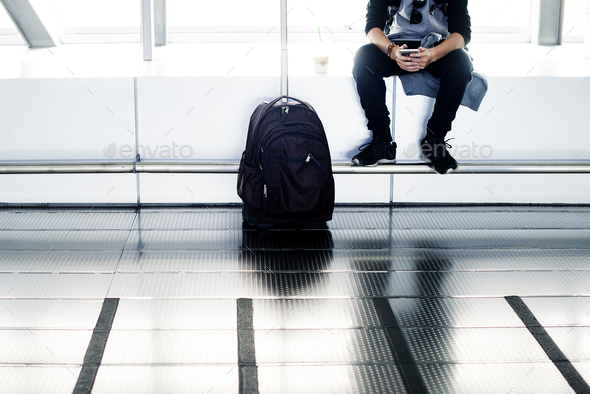 Young caucasian man travel with luggage in the airport
