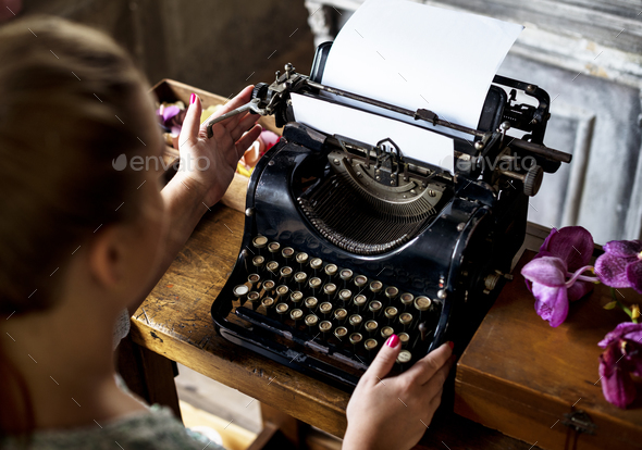 Woman typing typewriter on the table
