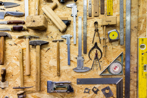 consumo adoptar creciendo work tools hanging on wall at workshop Stock Photo by dolgachov | PhotoDune