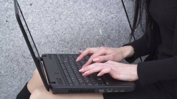 Woman's Hands Using Laptop