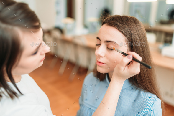 Make up artist work with woman eyes
