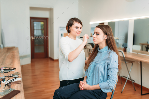 Female make up artist work with woman face