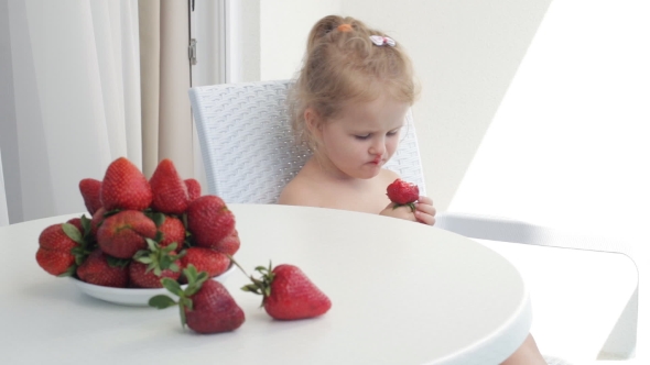 Young Girl Eating Strawberries