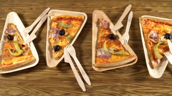 Slices of Pizza on Wooden Plates. Party Concept.