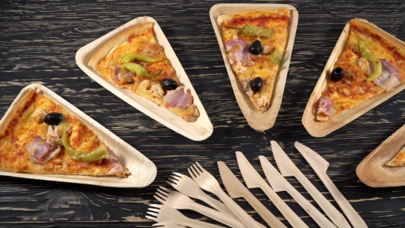 Slices of Pizza on Wooden Plates. Party Concept.