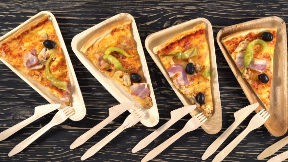 Slices of Pizza on Wooden Plates. Party Concept.