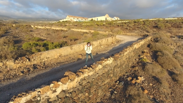Aerial View of Girl Taking Photo of Sea in Tenerife From Island in Sunset Time