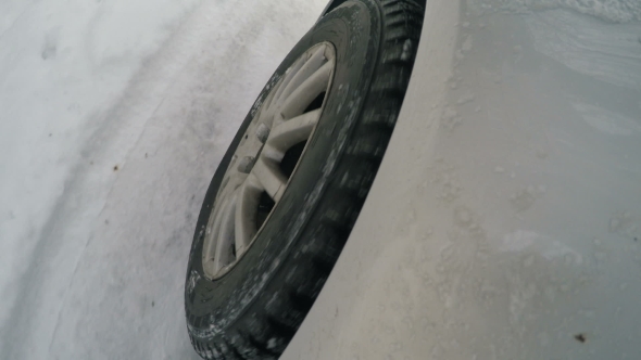 The Wheel of the Car on the Snowy Road alt