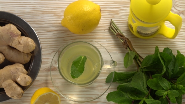 Ginger Tea with Lemon, Mint and Honey on Wooden Background.