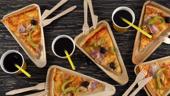 Slices of Pizza on Wooden Plates. Party Concept.