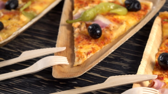 Slices of Pizza on Wooden Plates. Party Concept.