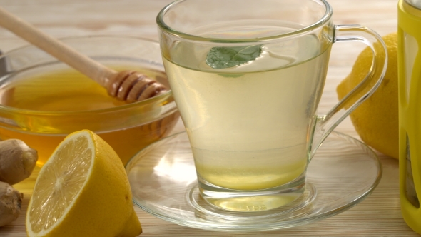 Ginger Tea with Lemon, Mint and Honey on Wooden Background.