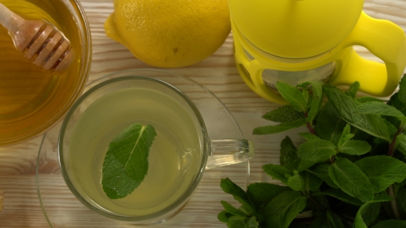 Ginger Tea with Lemon, Mint and Honey on Wooden Background.