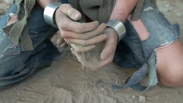 Prisoner in Chains on His Knees Touching the Dusty Ground alt
