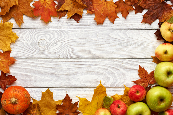 Autumn leaves, apples and pumpkin over wooden background Stock Photo by ...