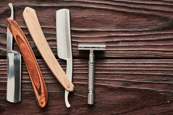 Vintage barber shop razor tools on wooden background Stock Photo by