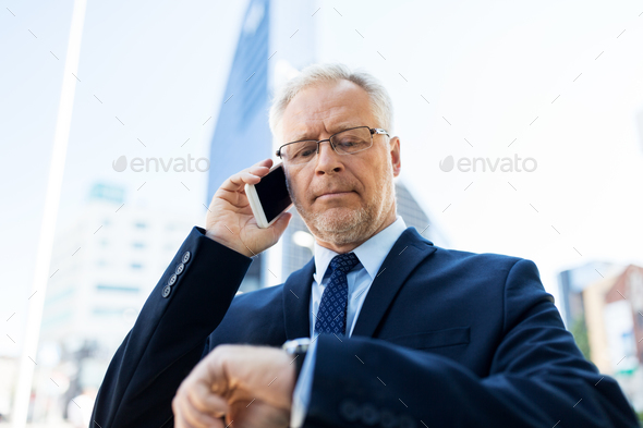 senior businessman calling on smartphone in city - Stock Photo - Images