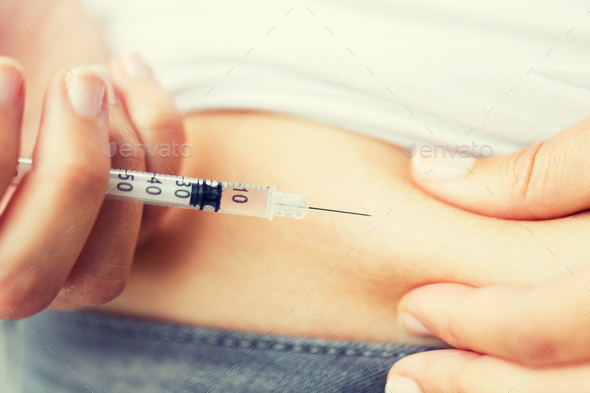 woman with syringe making insulin injection - Stock Photo - Images