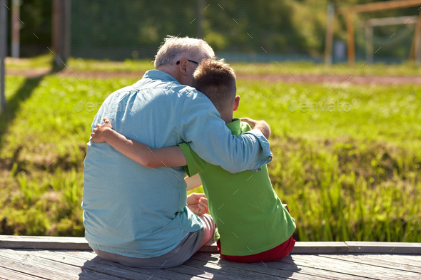 grandfather and grandson hugging on berth - Stock Photo - Images