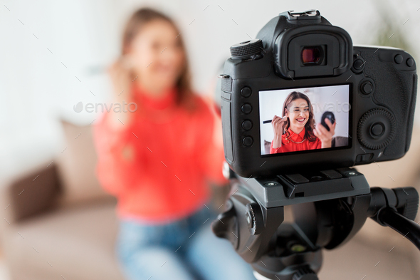 woman with bronzer and camera recording video - Stock Photo - Images