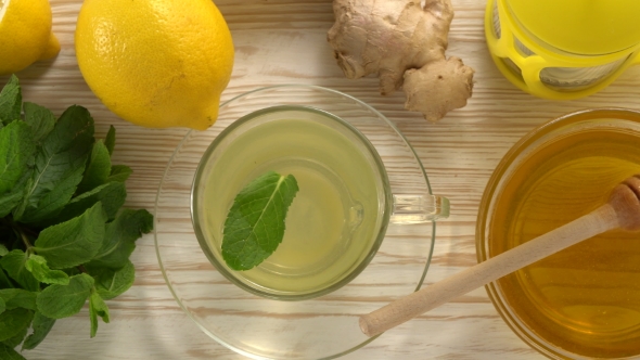 Ginger Tea with Lemon, Mint and Honey on Wooden Background.