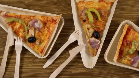 Slices of Pizza on Wooden Plates. Party Concept.