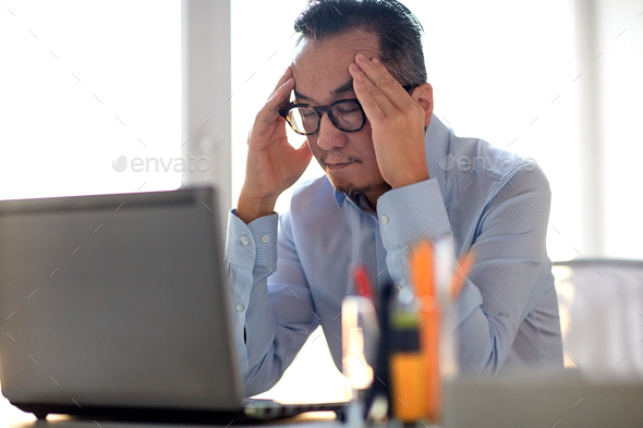 businessman in eyeglasses with laptop at office - Stock Photo - Images