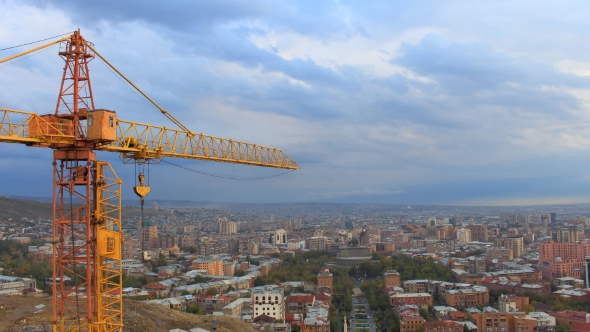 Orange Crane on a Background Moving Clouds