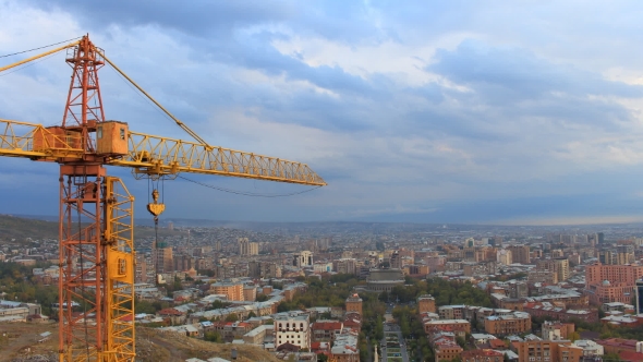 Orange Crane on a Background Moving Clouds