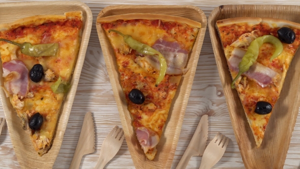 Slices of Pizza on Wooden Plates. Party Concept.