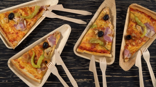 Slices of Pizza on Wooden Plates. Party Concept.