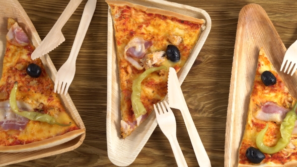 Slices of Pizza on Wooden Plates. Party Concept.