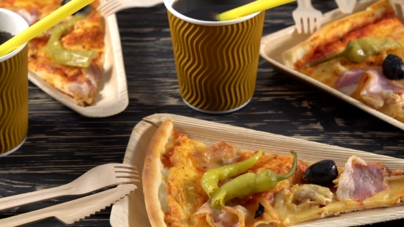 Slices of Pizza on Wooden Plates. Party Concept.